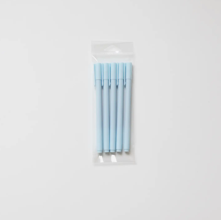 Set of light blue pens in a clear plastic package on a white background
