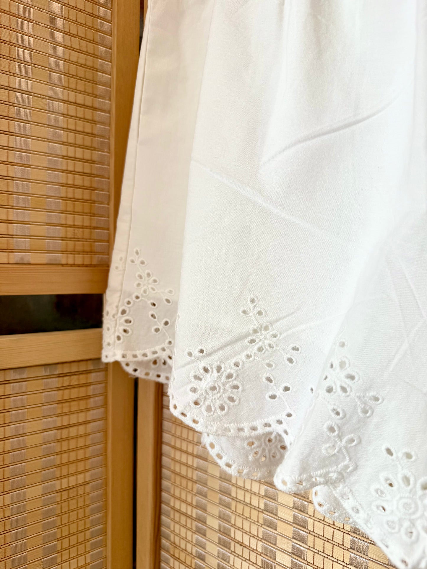Elegant boutique shorts with feminine scallop detail.