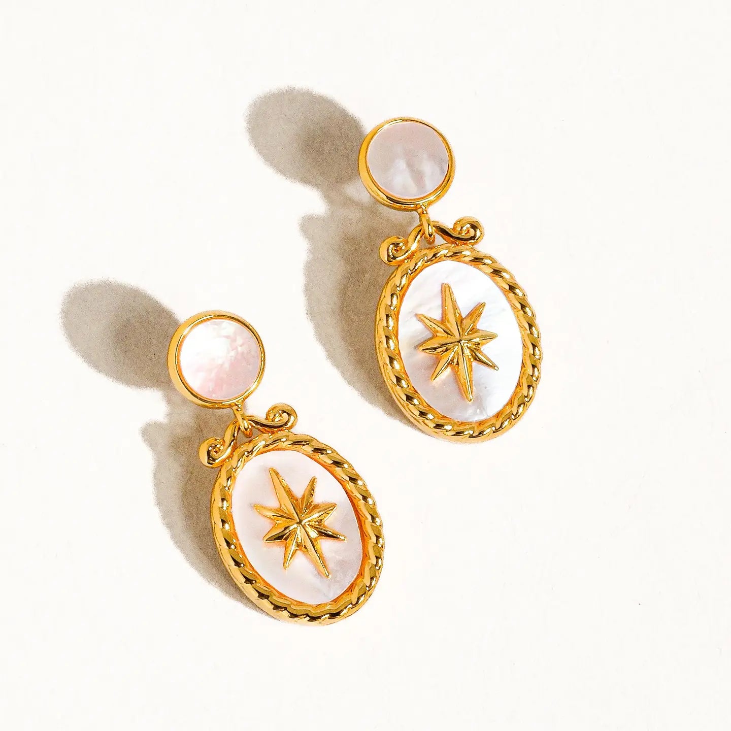 “Golden Shoreline” – Star shell earrings on a sandy shell-covered background with sunlight
“Vintage Coastal Glow” – Earrings displayed on a linen cloth with dried florals and a pearl comb
“Seashell Chic” – Earrings styled on a model with beachy waves and a white sundress
