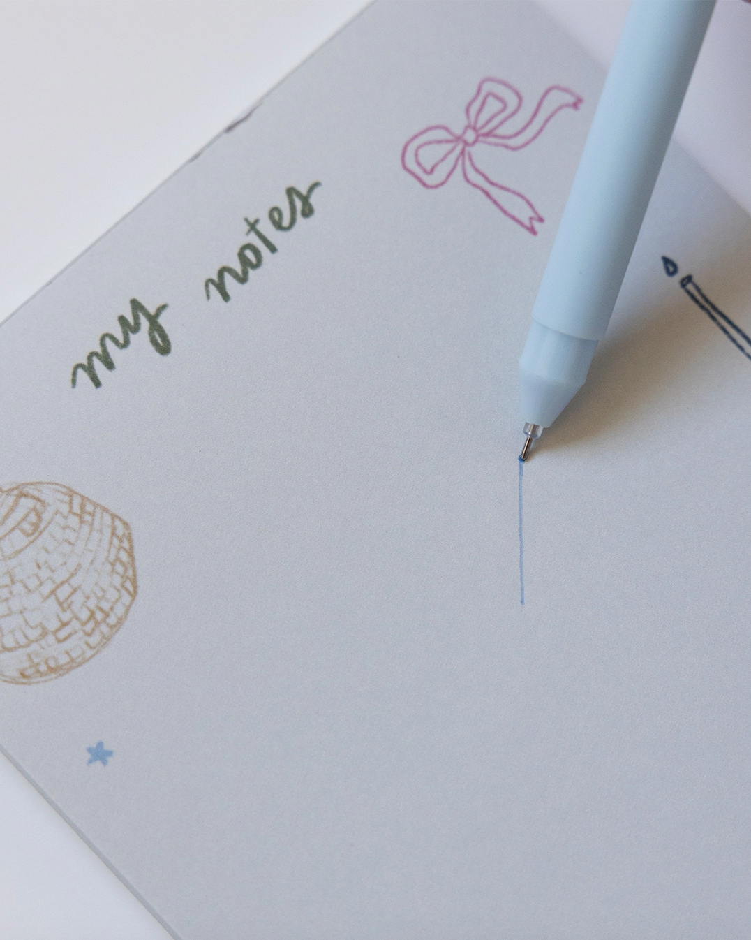 Notebook with 'my notes' text and a pen on a white background