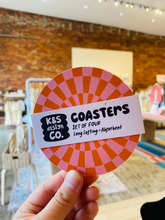 “Retro Pop Coaster Set” – Bright orange and pink coasters styled with vintage glassware

“Color Splash Coasters” – Overhead view of fun, retro-inspired coasters on a party table