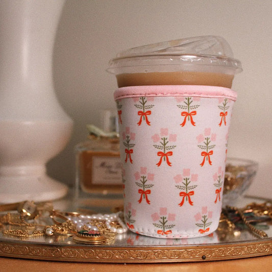 "Caffeinated & Cute" – Medium iced coffee in a printed sleeve with sunglasses and lipstick nearby

"Cold Brew, No Chill" – Close-up of coffee sleeve hugging a venti Starbucks cup on a sunny day

"Sip Happens" – Flatlay of multiple sleeves in fun prints next to a planner and pastel pens