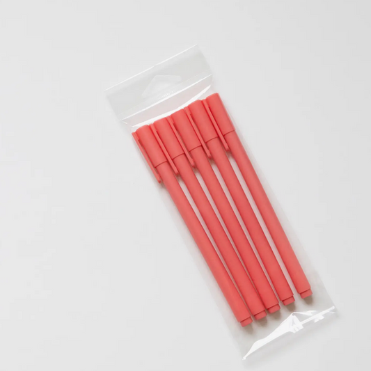 Set of red pens in a clear plastic package on a white background