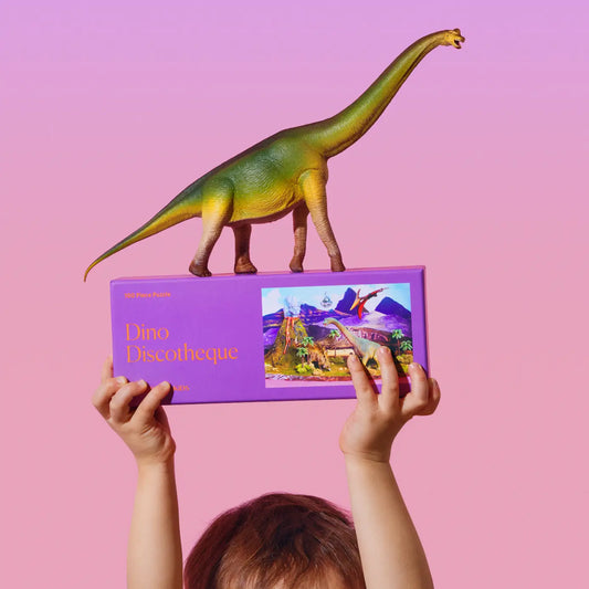 “Dino Disco Dancefloor” – Vibrant puzzle art showing dancing dinosaurs with disco lights

“Jurassic Party Puzzle” – 100-piece Dino Discotheque puzzle fully assembled on a table