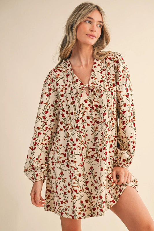 “Corduroy Cutie” – Model standing in a floral mini dress with hands in pockets

“Tie the Look Together” – Close-up of the neckline tie and pintuck detail

“Puffed & Pretty” – Side view showing puff sleeves and flowing silhouette