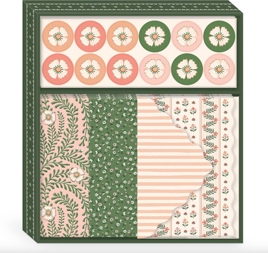 Packaging of stationery items with floral and geometric patterns on a white background