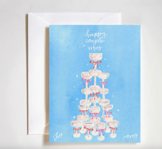 Greeting card with a tower of glasses and 'happy couple vibes' text on a blue background