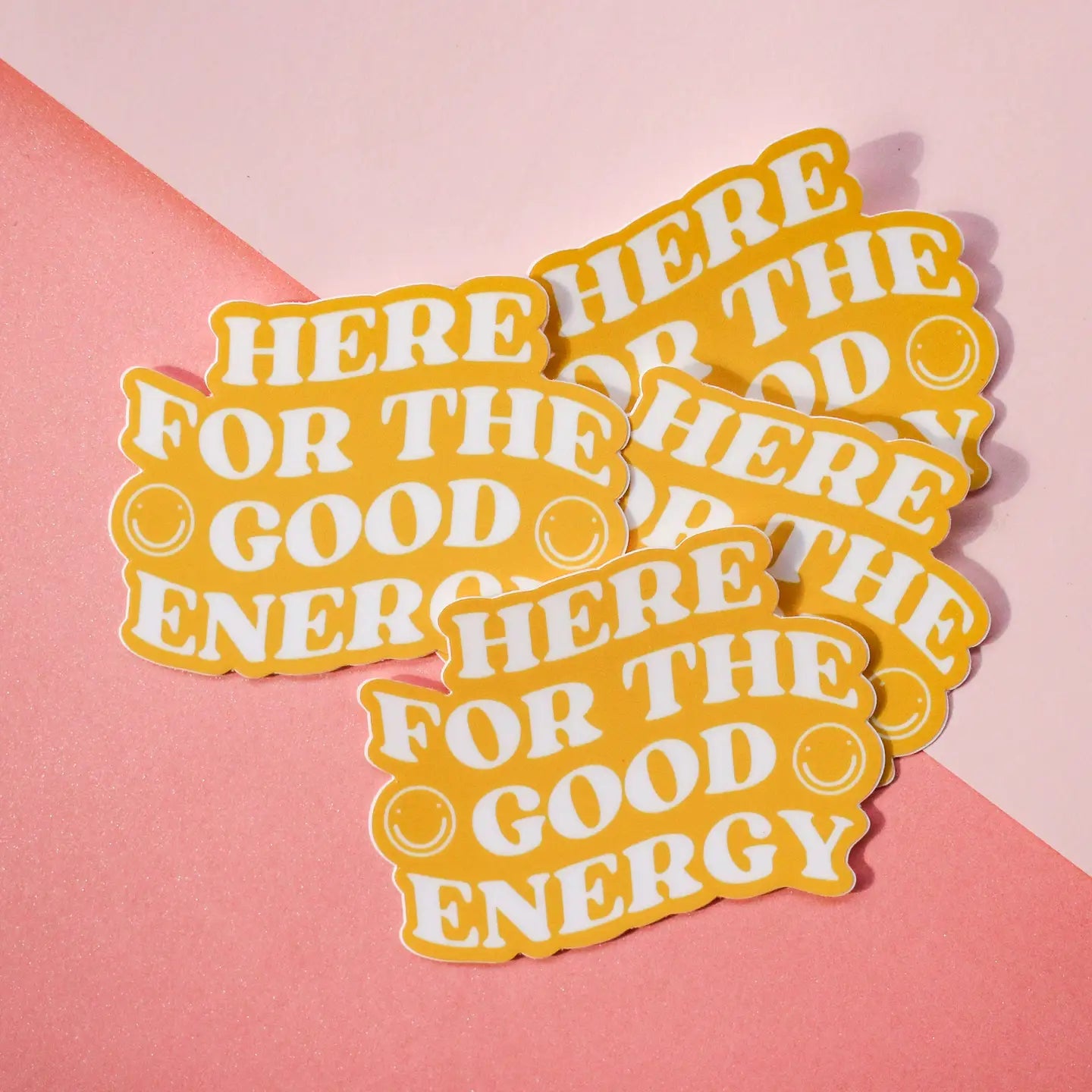 “Good Vibes Only” – Close-up of “Here for the Good” sticker on a sleek laptop

“Spread the Sunshine” – Sticker on a pastel water bottle surrounded by cozy café vibes

“Matte Magic” – Sticker on a phone case with soft natural lighting