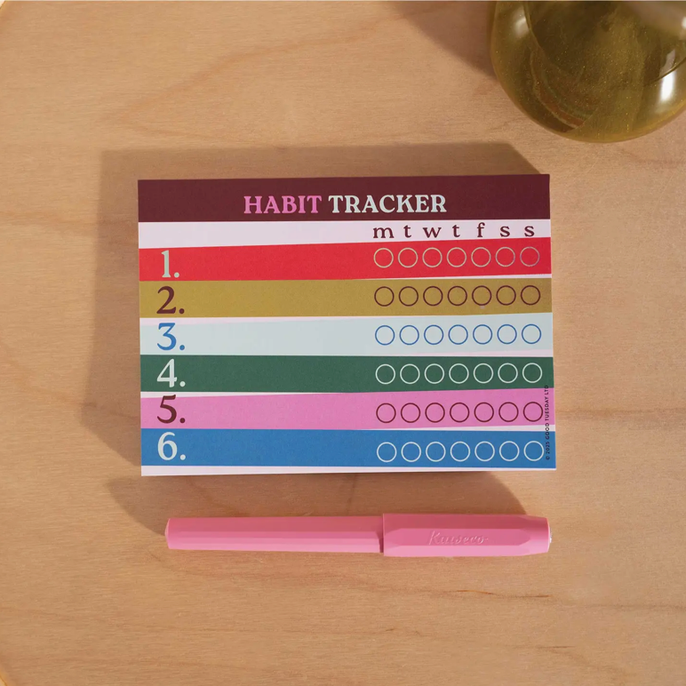 Habit tracker with colorful design on a wooden surface