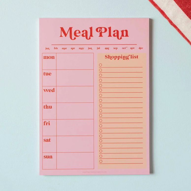 Meal plan and shopping list notepad on a light blue background