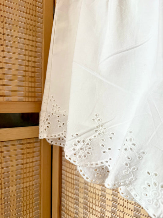 Elegant boutique shorts with feminine scallop detail.