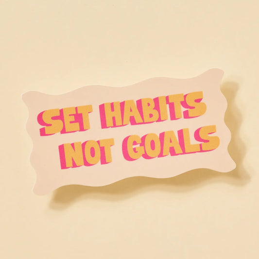 “Habit Over Hype” – Close-up of sticker showing hand-lettered text and colorful border

“Motivation on Repeat” – Sticker on a mirror surrounded by morning essentials

“Tiny but Mighty” – Sticker on a journal with cozy desk vibes and stationery