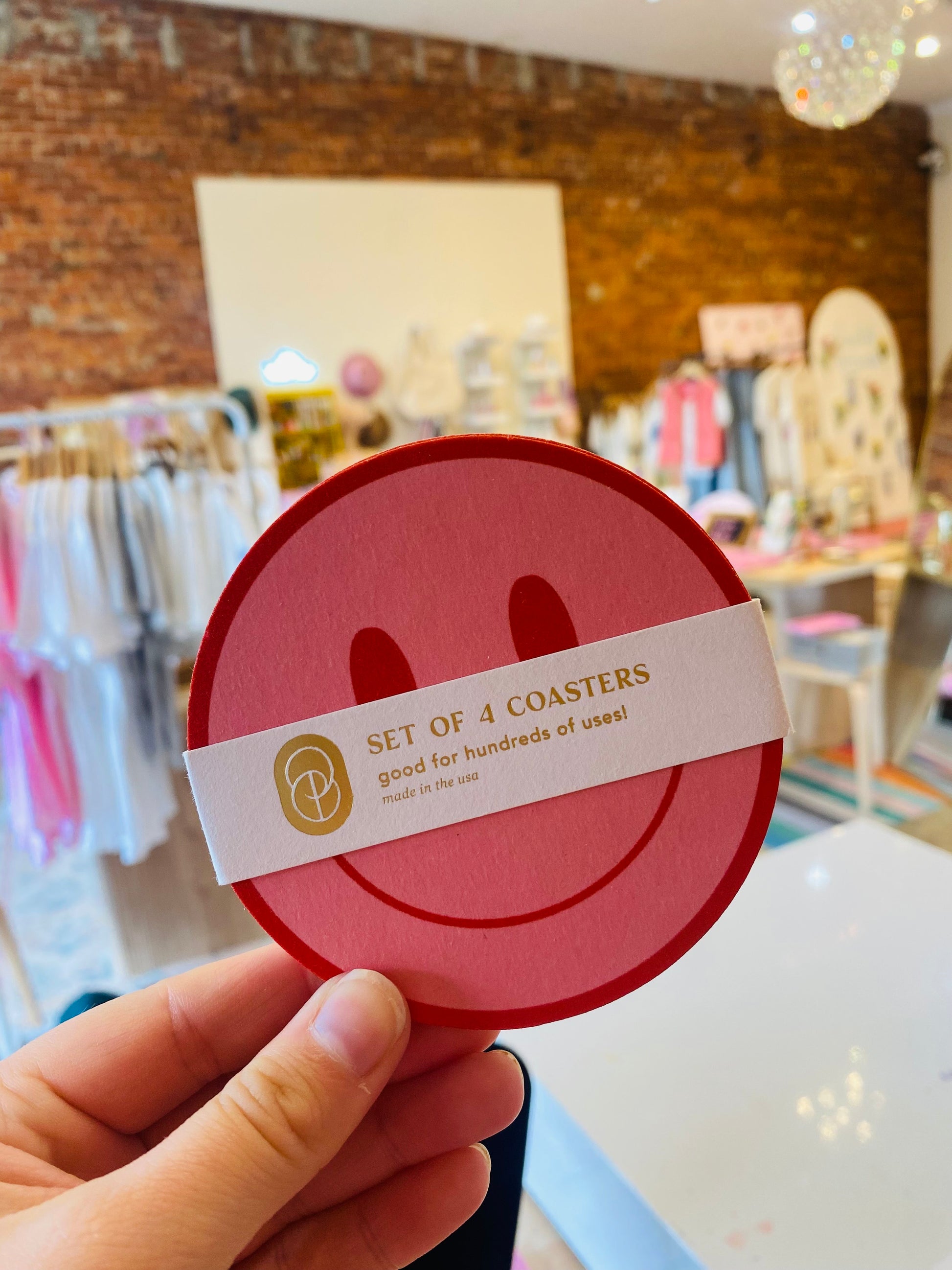 “Smiley Sips Set” – Flat lay of four pink smiley coasters with drinks & florals

“Good Vibes, Pink Coasters” – Close-up of vibrant smiley face coaster on a styled tray