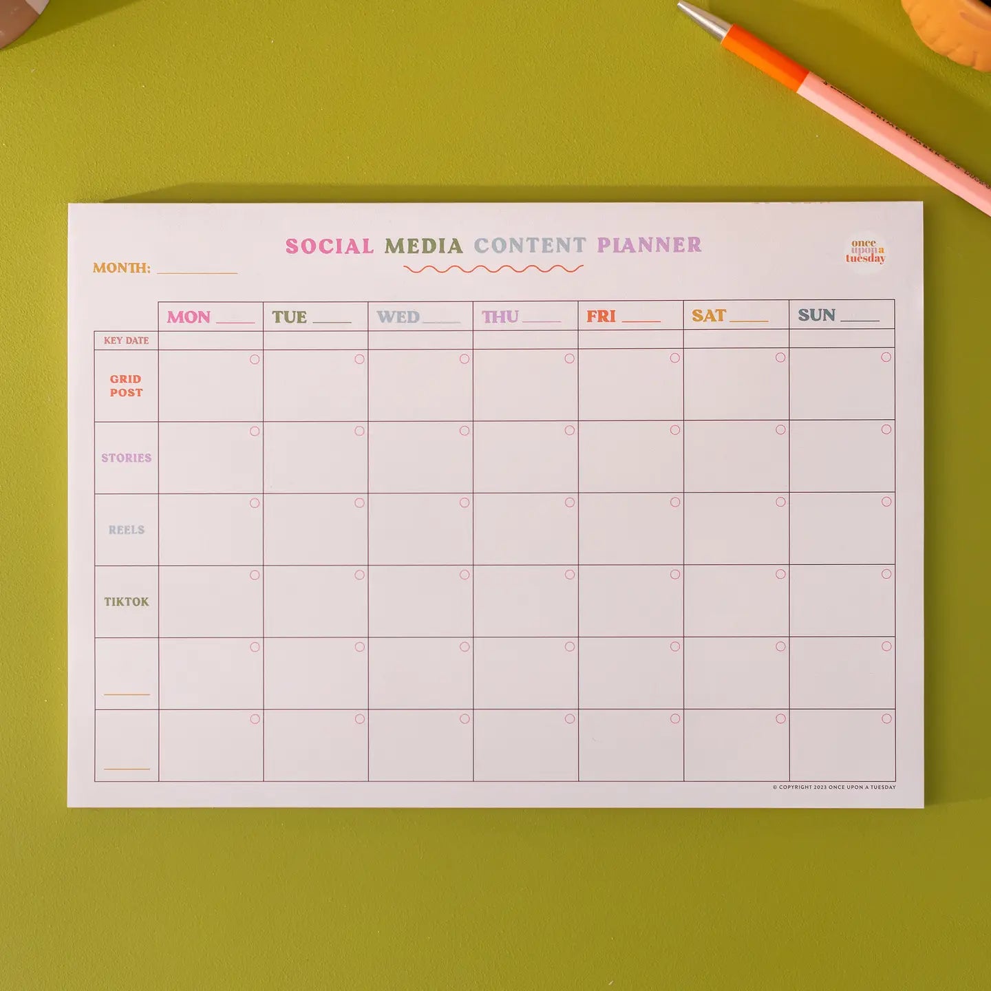 "Content Queen Planner" – A4 pad with weekly grid, styled with phone, coffee, and laptop

"Plan It, Post It!" – Flatlay of content planner mid-use, with handwritten platform names

"Social Sorted Weekly" – Zoomed-in shot of clean layout with colourful markers and planning notes