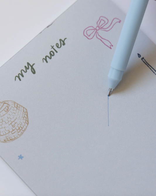 Notebook with 'my notes' text and a pen on a white background