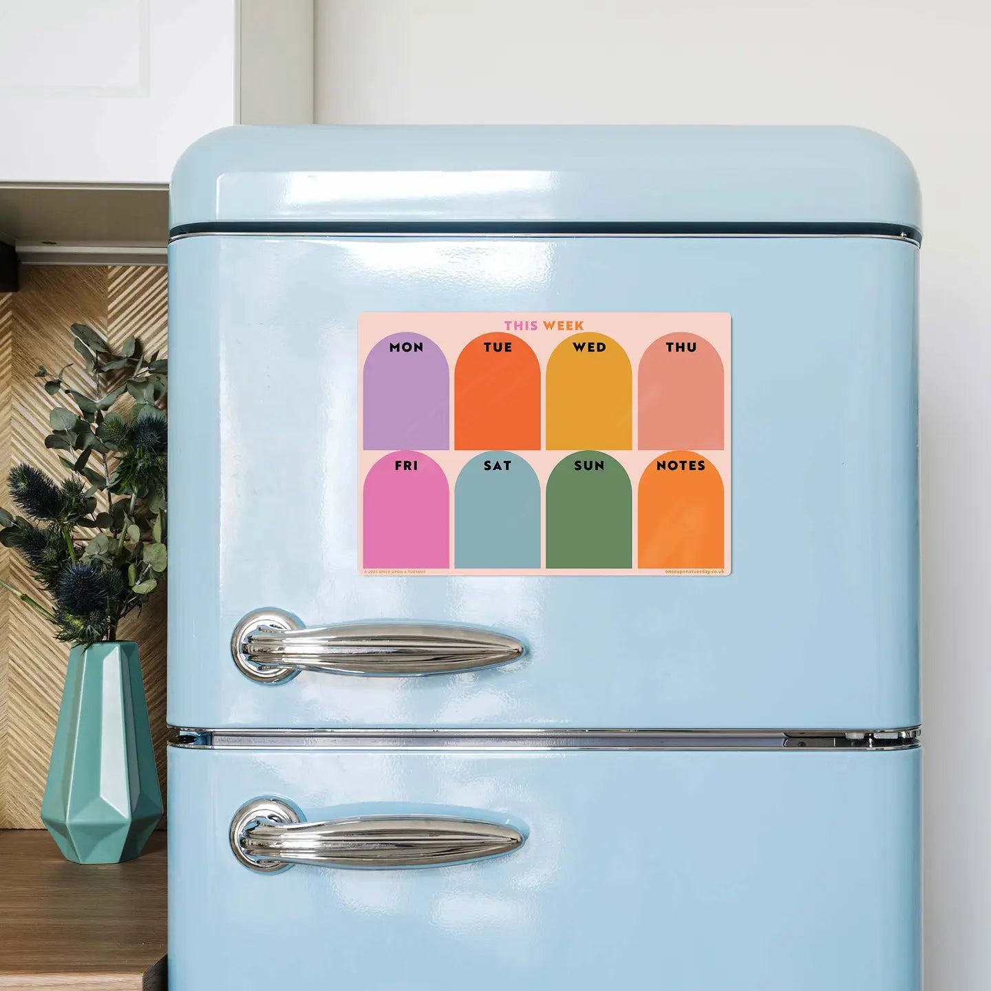 "Fridge Fab Week Plan" – Weekly calendar magnet styled with pastel pens and a plant nearby

"Write. Wipe. Repeat." – Close-up of glossy surface with handwritten weekly tasks

"Magnetic Monday Motivation" – Fridge view with the calendar front and center