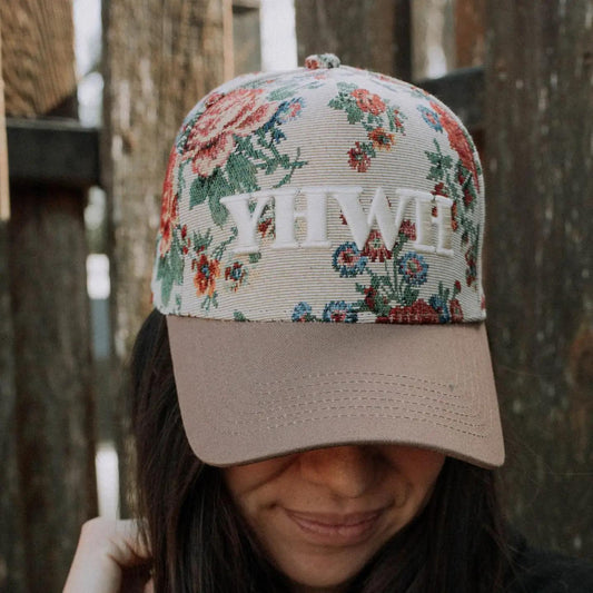 “YHWH Floral Embroidered Hat” – Styled with a Bible and dried florals on a linen background

“Faith-Based Floral Cap with Brown Bill” – Close-up of white embroidery and floral cotton detail